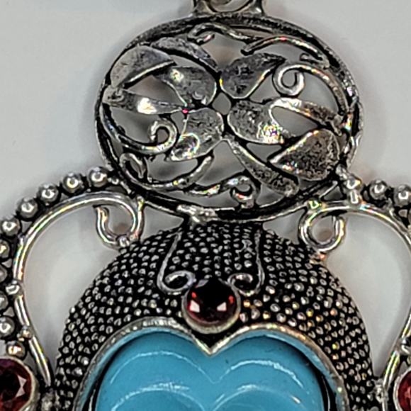 Sterling Silver Pendant with Blue Carved Face and Garnet Accents - Picture 10 of 12